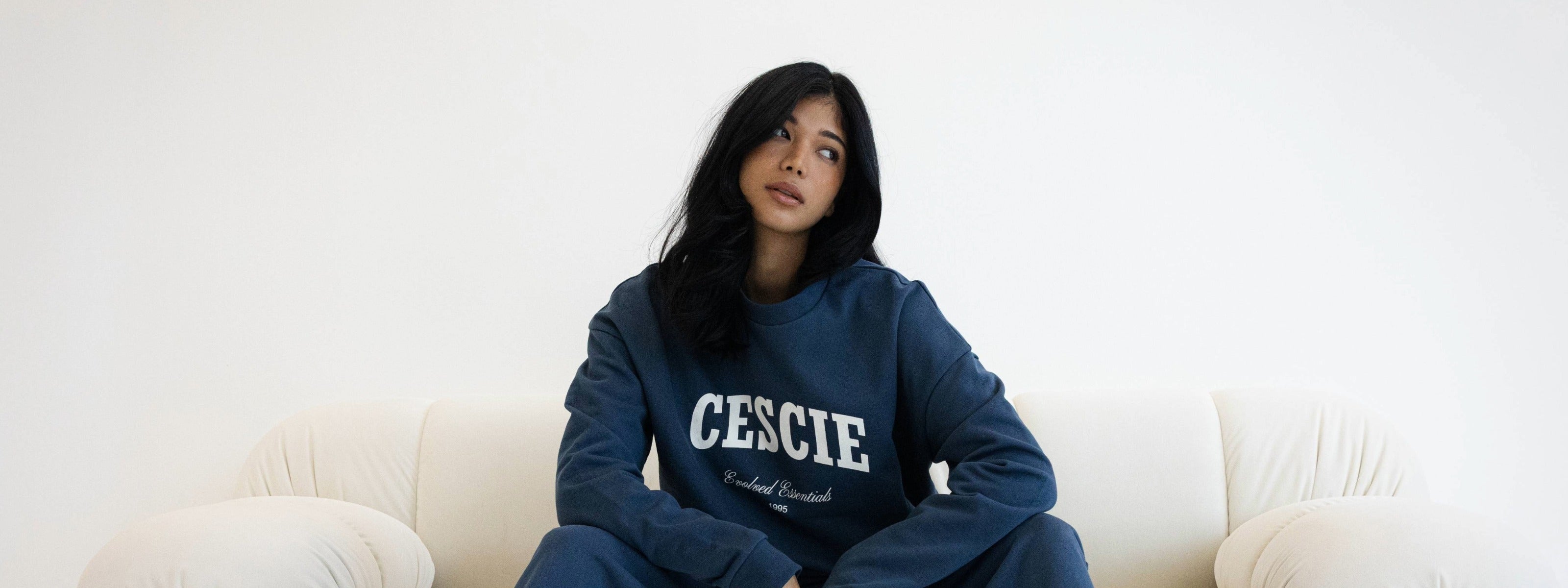 Model wearing washed navy cescie essentials sweatshirt and joggers